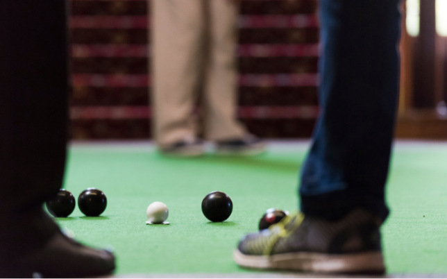 A selection of people playing carpet bowls